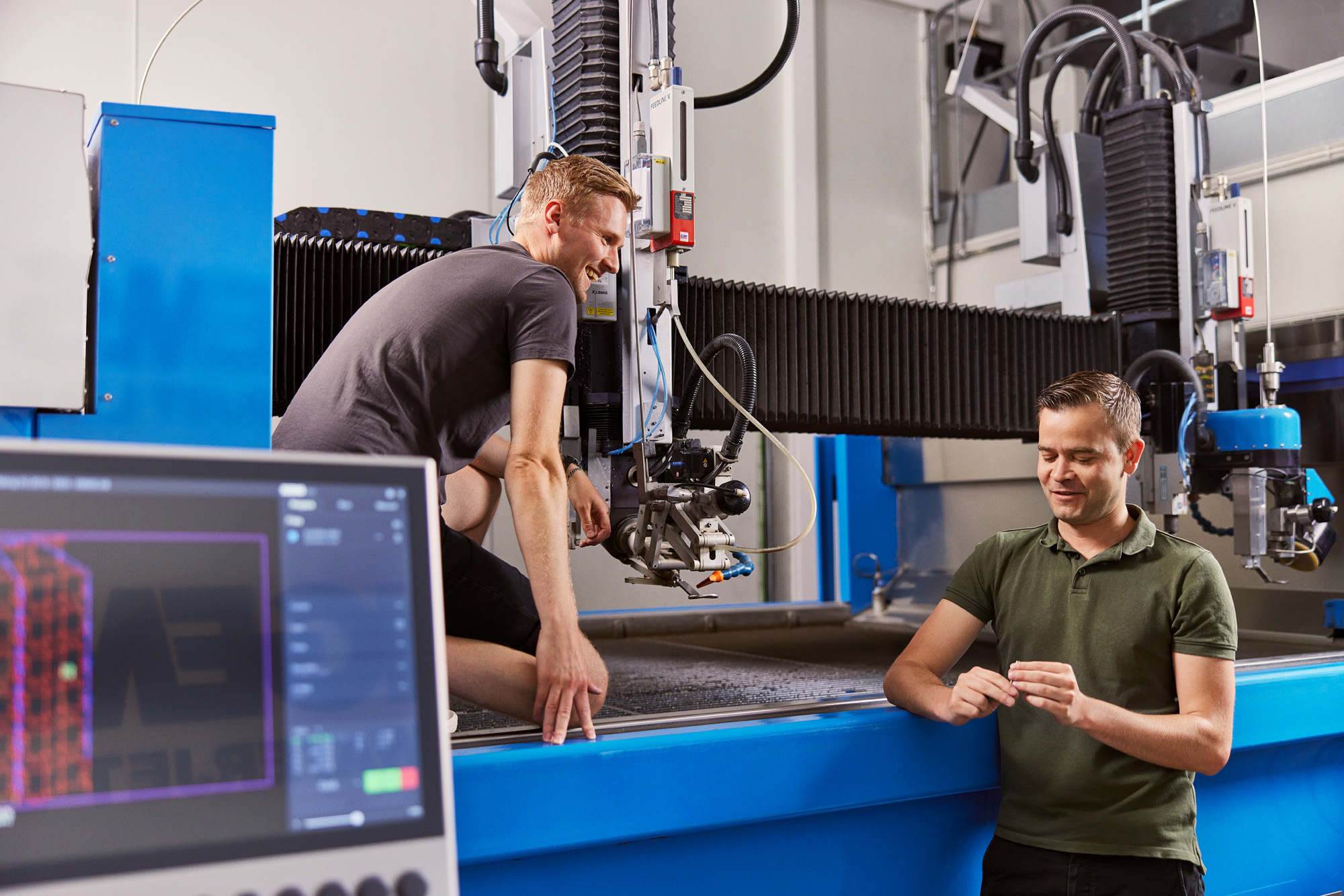 IGEMS waterjet cutting software next to waterjet cutting system.
