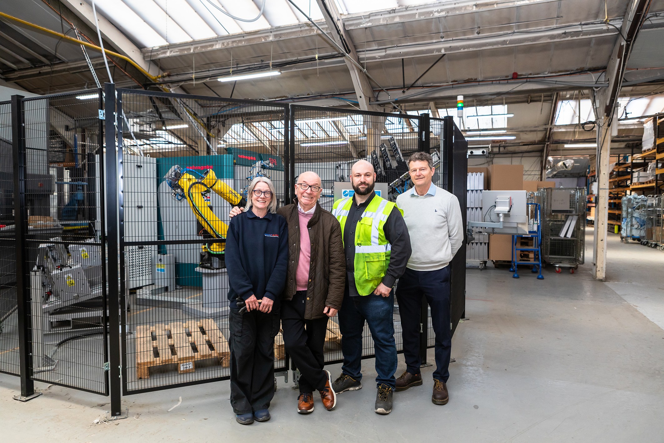 The Penn Elcom team in front of its new robotised bending cell.