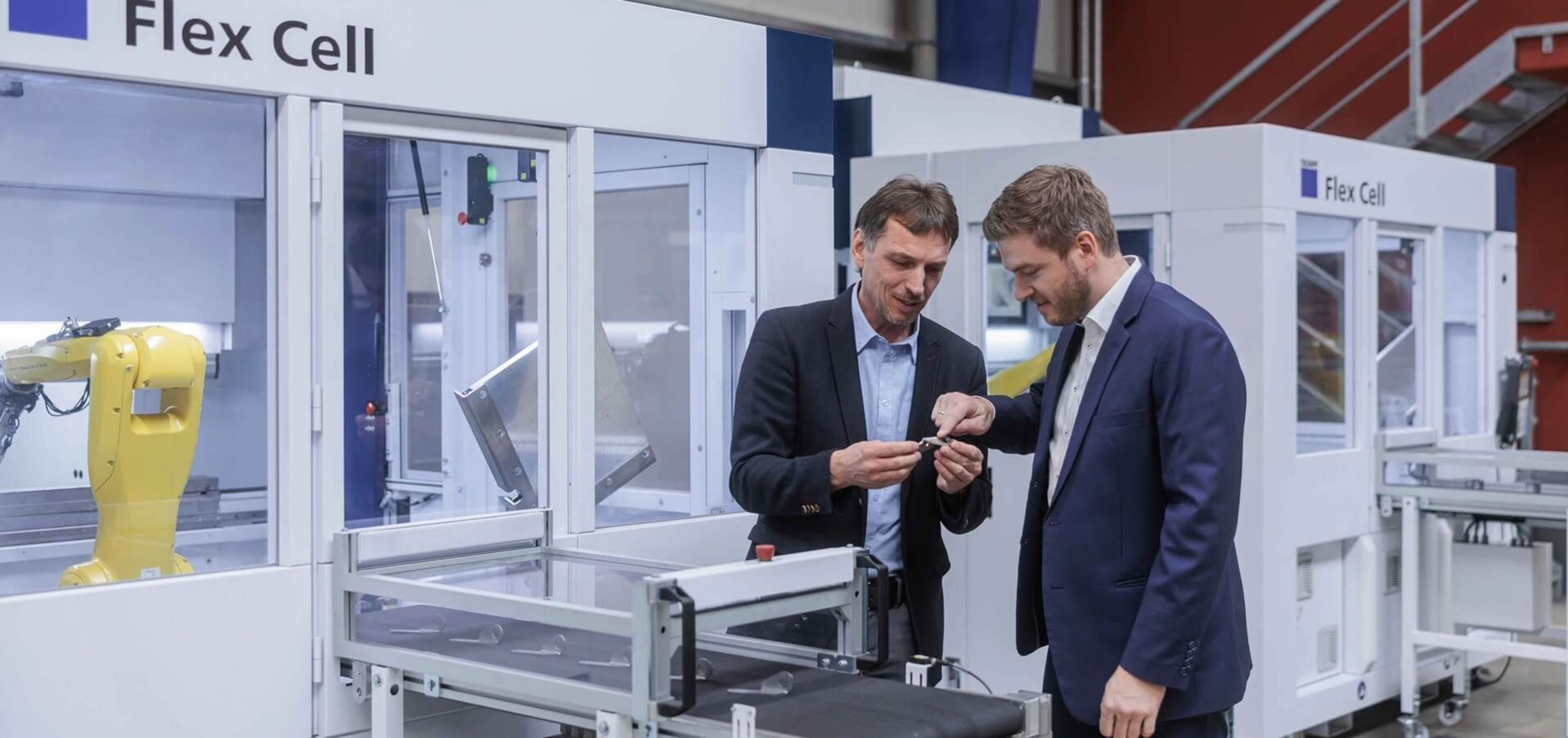 Ferdinand Steinhuber (left), Managing Director of S&S Steinhuber GmbH, examines the processing quality of the automated TruBend 7050 in conversation with Wolfgang Radler (right), Product Manager, TRUMPF Maschinen Austria. (image source: TRUMPF).)