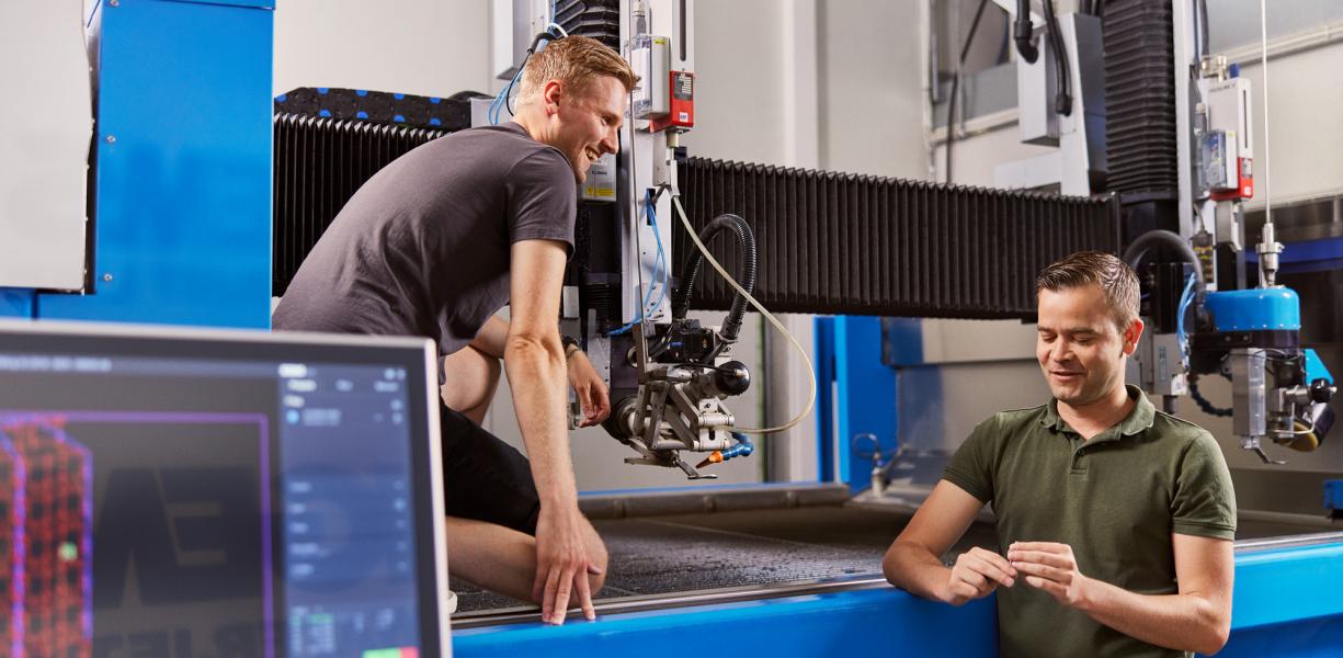 IGEMS waterjet cutting software next to waterjet cutting system.